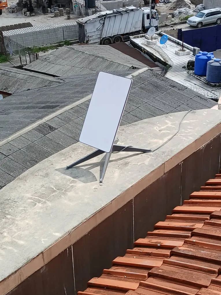 Starlink dish on the parapet with a clear view over neighbouring roofs