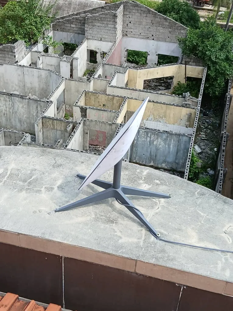 Starlink dish on the rooftop parapet, angled to the open sky