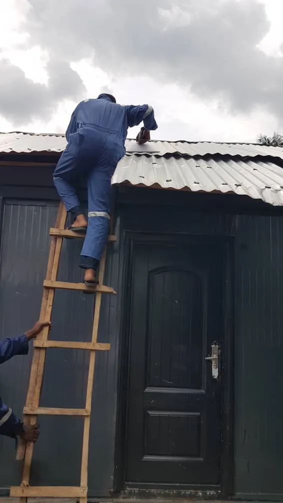 Installer fixing the Starlink dish on the container roof