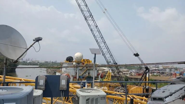 Starlink dish beside the existing VSAT dish on the upper deck of a crane barge