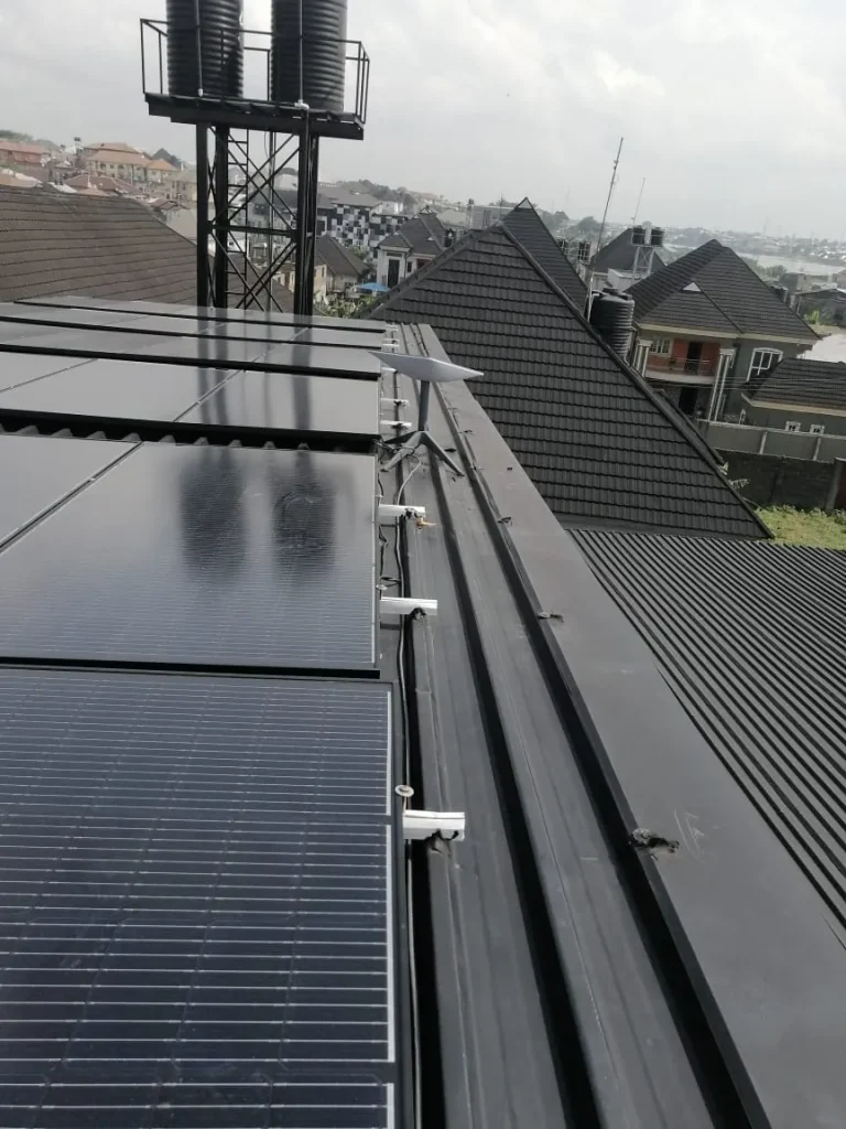 Starlink dish on the roof ridge of a duplex between the solar panels