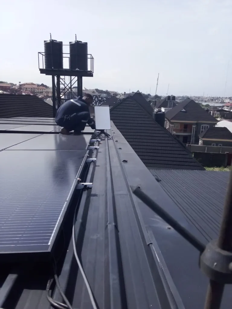 ZuraLink installer fixing the Starlink dish on the roof ridge