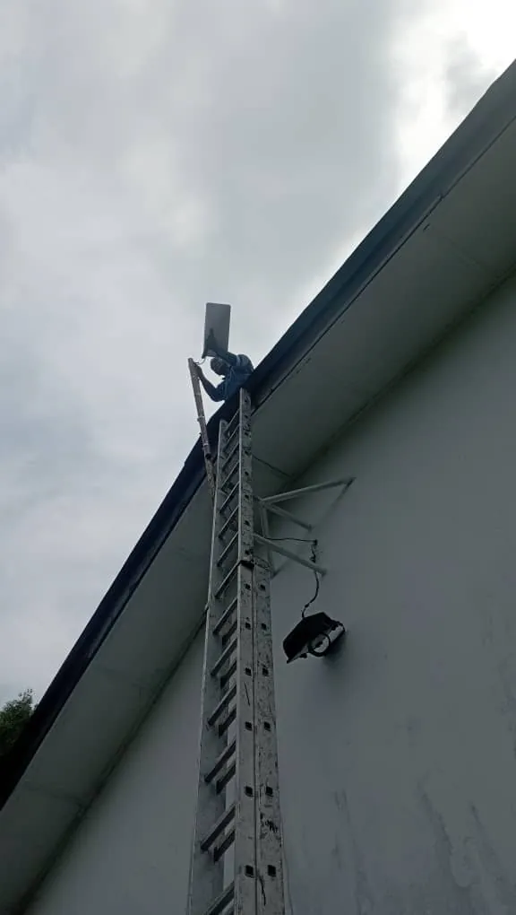 Starlink dish mounted on the wall bracket at the gable edge