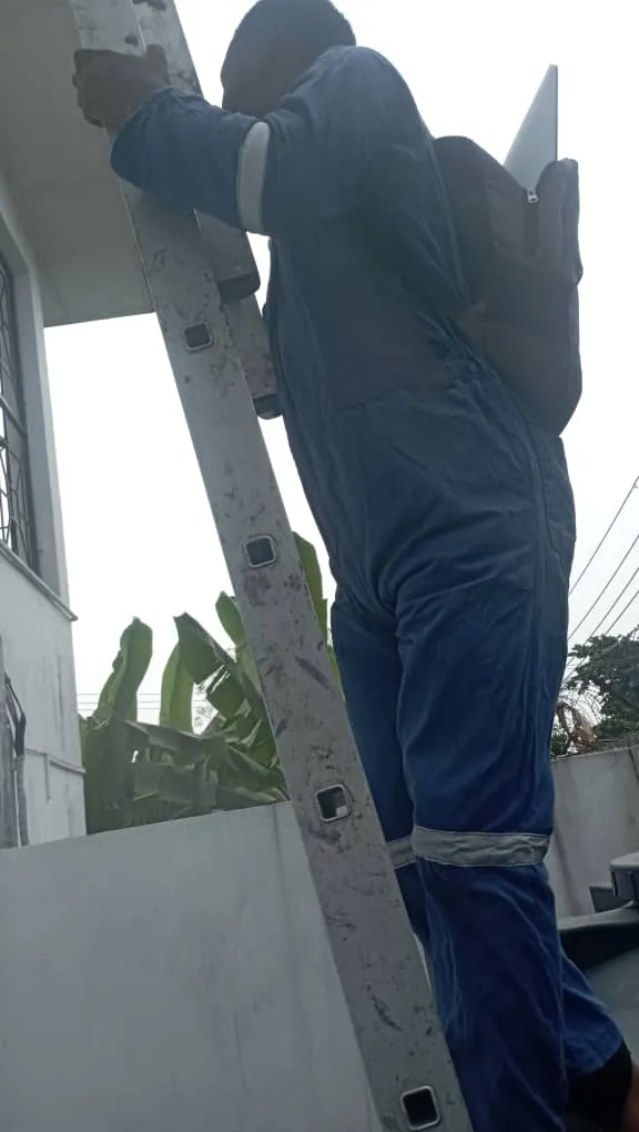 ZuraLink installer climbing to the gable-edge Starlink bracket