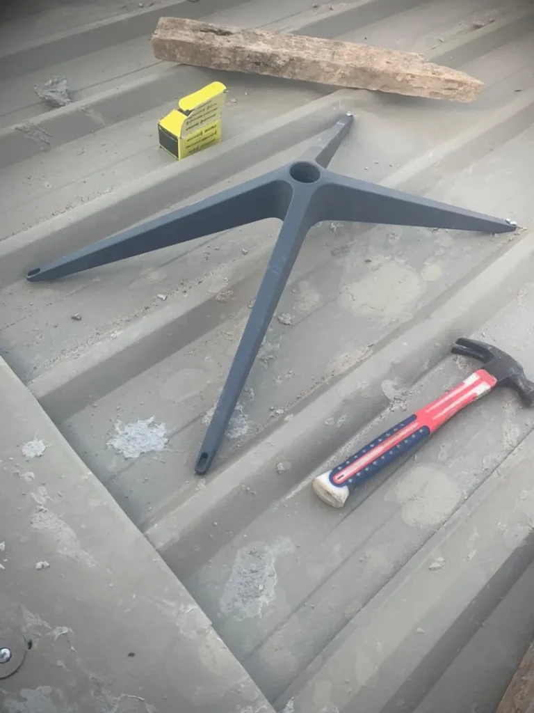 Starlink base being fixed to the corrugated metal roof