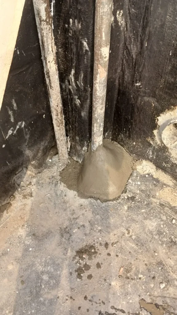 Base of the Starlink pole set in fresh concrete on the roof