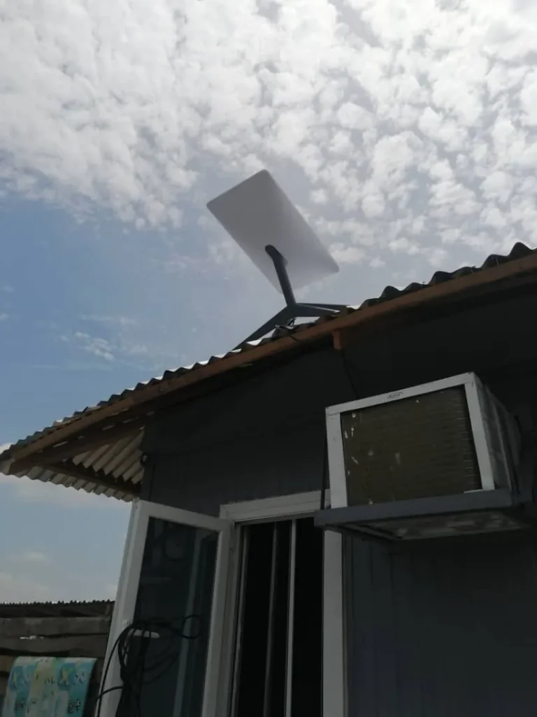 Starlink dish above the cabin's roof edge