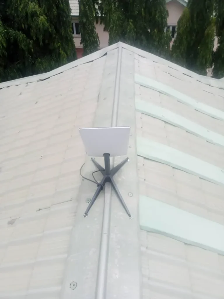 Starlink dish fixed on the ridge of a stone-coated roof