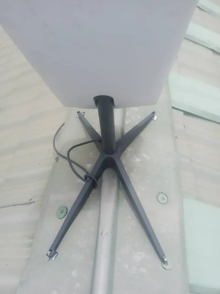 Close-up of the Starlink base secured on the roof ridge