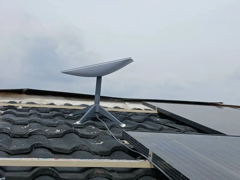 Starlink dish on the tiled roof beside the solar panels