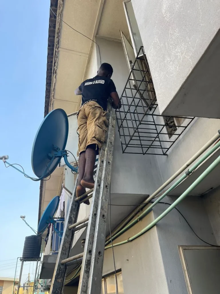 ZuraLink installer climbing to the roof of a two-storey home
