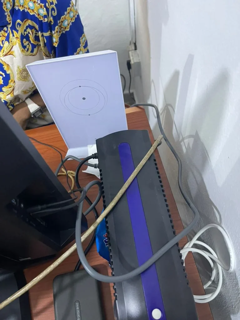 Starlink router set up beside the customer's desk