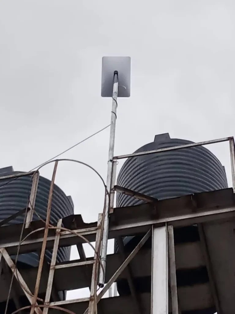 Starlink dish raised above the water tanks on the tower