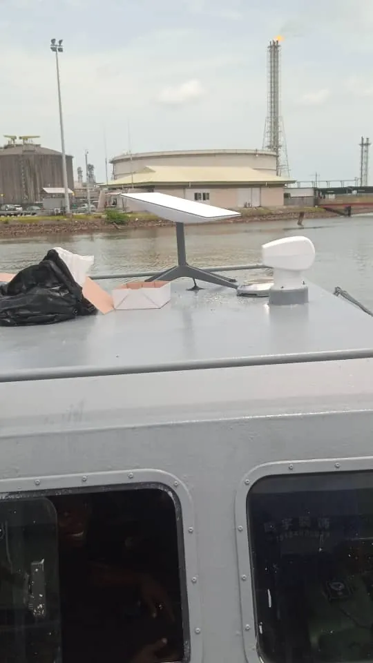 Starlink dish installed on the cabin roof of a work boat at a harbour