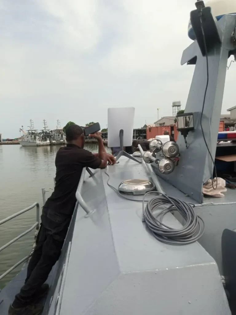 Installer fixing the Starlink cable on the boat
